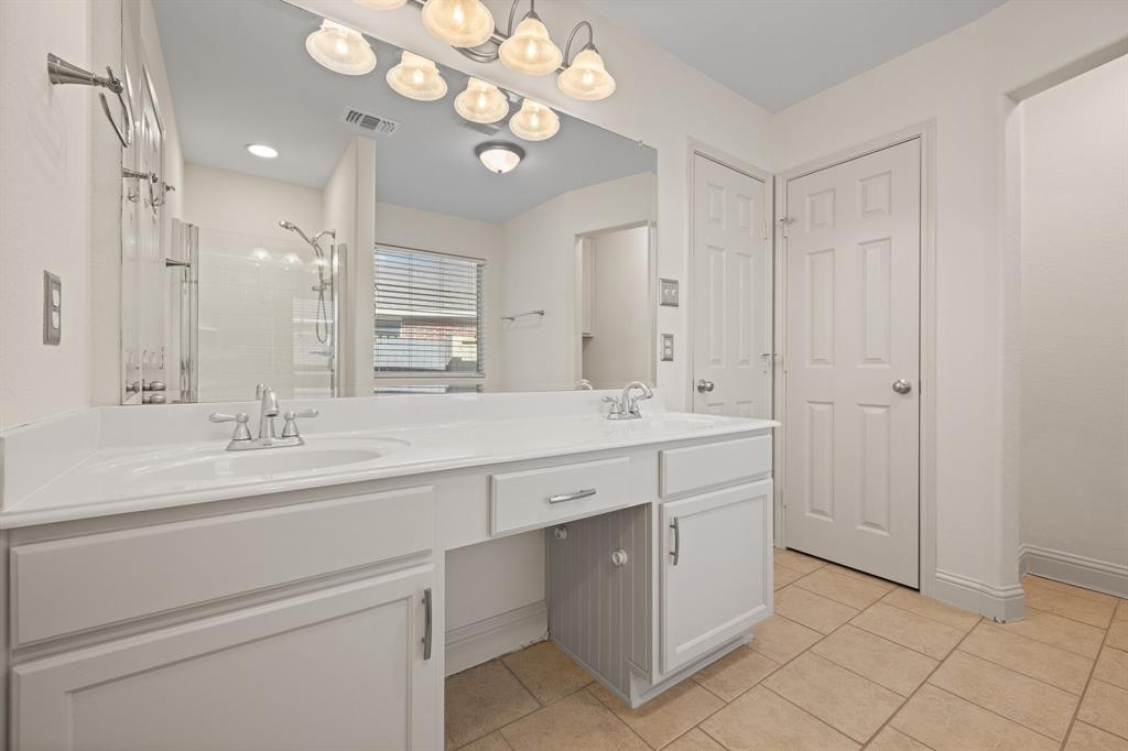 7103 Camp Creek Drive Arlington, TX 76002 - Photo 21 of 29 a bathroom with a double vanity sink and a mirror
