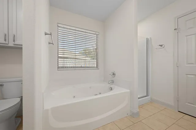 a white bath tub sitting next to a toilet