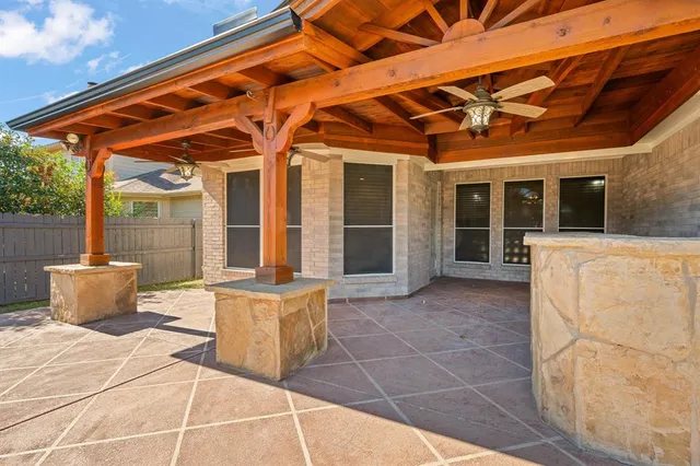 a view of a patio with table and chairs