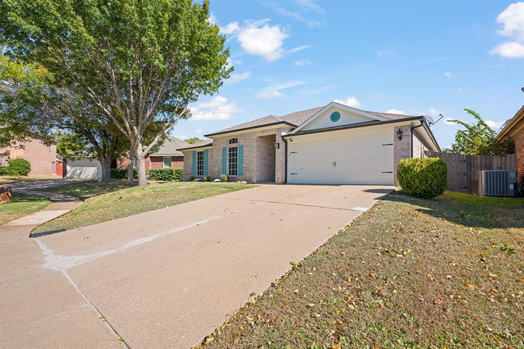 7103 Camp Creek Drive Arlington, TX 76002 - Photo 29 of 29 a front view of a house with a yard and garage