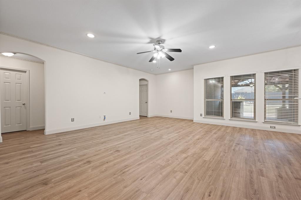 7103 Camp Creek Drive Arlington, TX 76002 - Photo 5 of 29 a view of empty room with wooden floor and fan