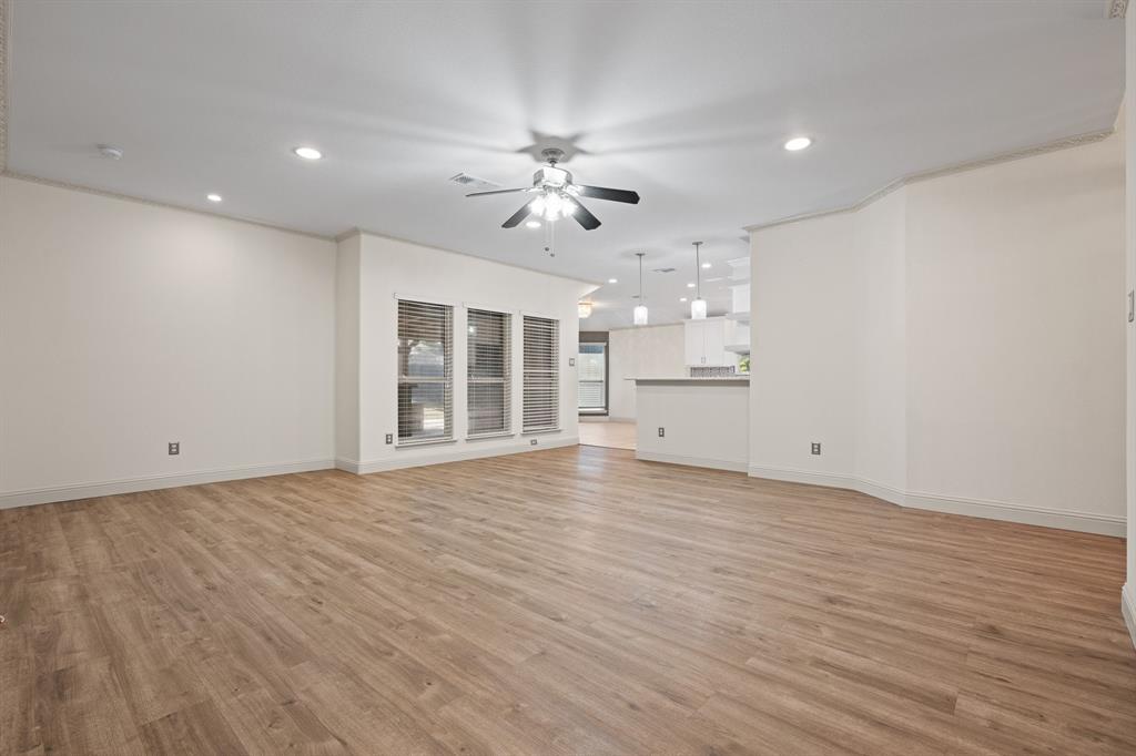 7103 Camp Creek Drive Arlington, TX 76002 - Photo 6 of 29 a view of an empty room with a window and wooden floor