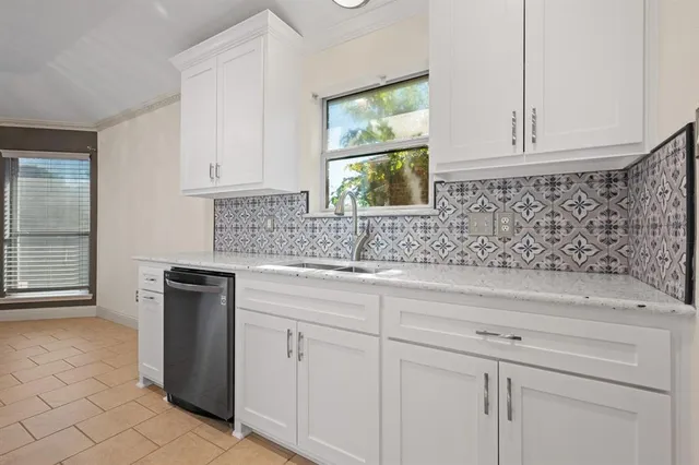 a kitchen with granite countertop white cabinets and white appliances