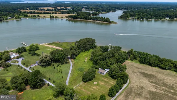 an aerial view of a houses with a lake view