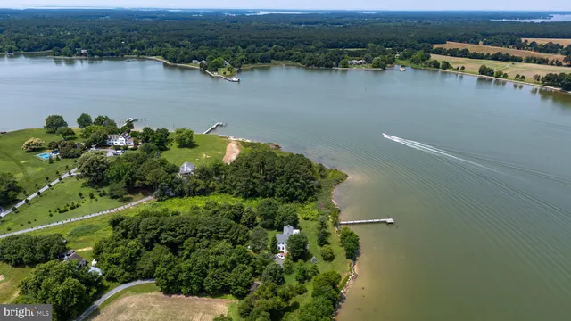 an aerial view of a houses with a lake view
