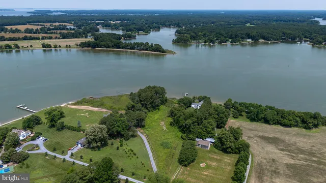 an aerial view of a houses with a lake view