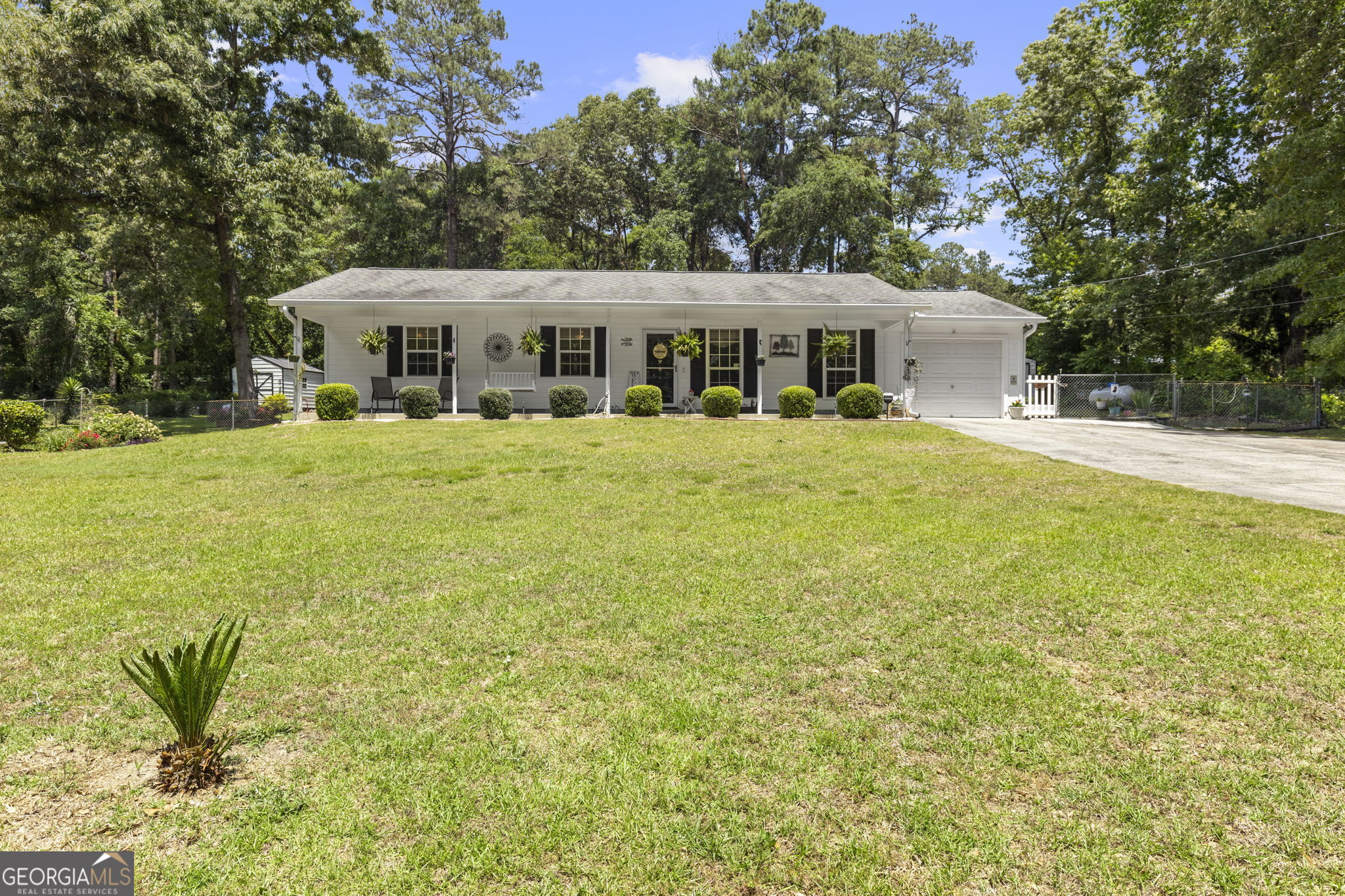 305 North Lake Drive Perry, GA 31069 - Photo 1 of 32 a front view of a house with a garden