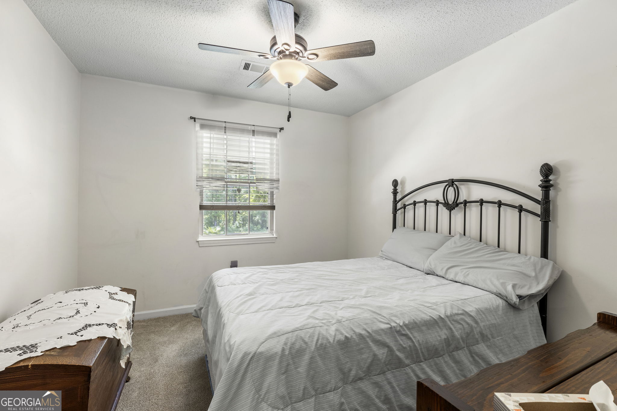 305 North Lake Drive Perry, GA 31069 - Photo 20 of 32 a bedroom with a bed and a window