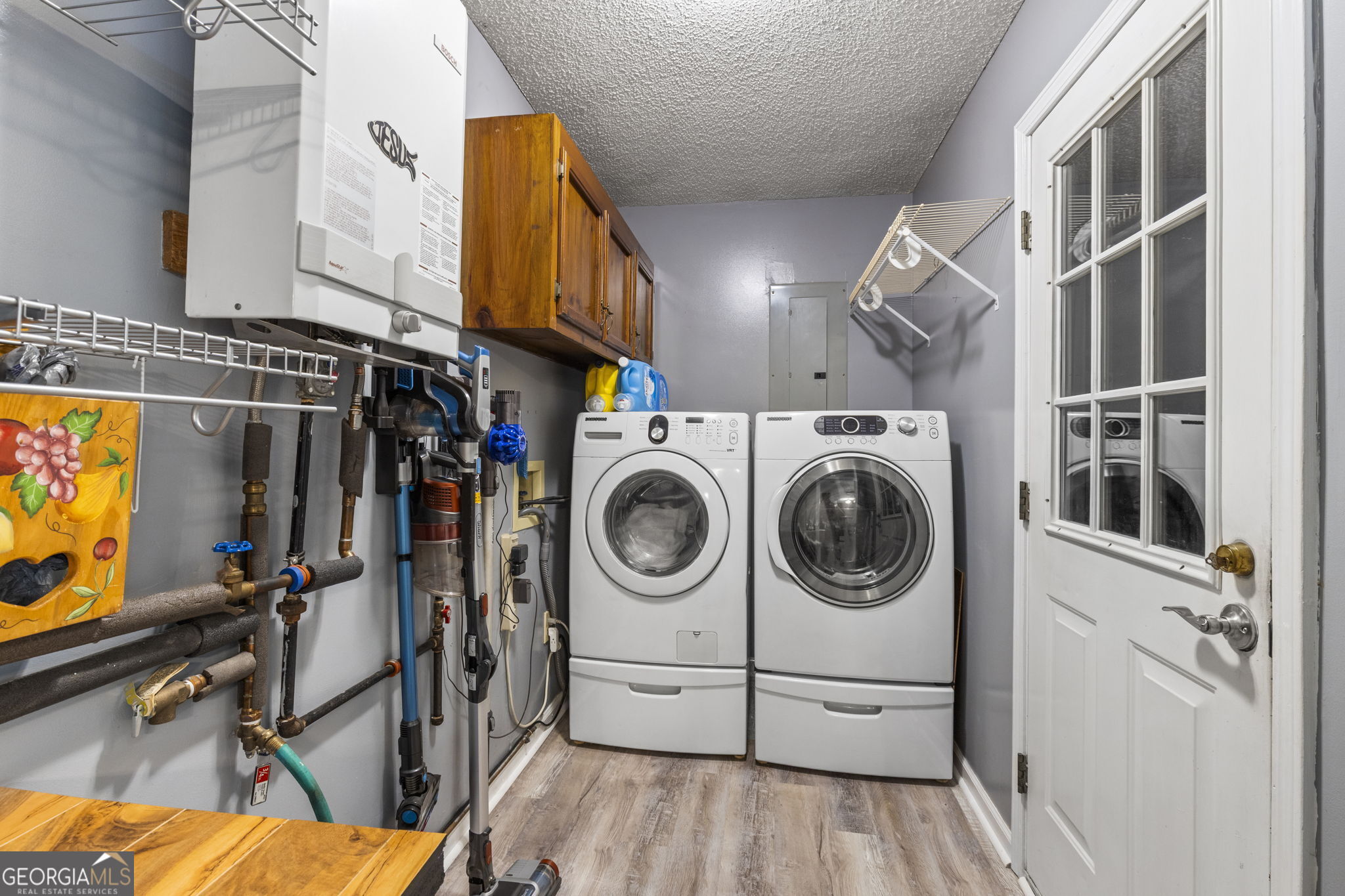 305 North Lake Drive Perry, GA 31069 - Photo 23 of 32 a utility room with dryer washer and a view of living room