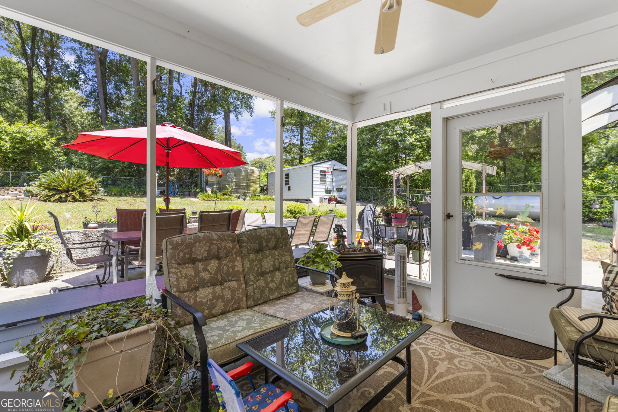 305 North Lake Drive Perry, GA 31069 - Photo 24 of 32 a living room with patio furniture and a potted plant
