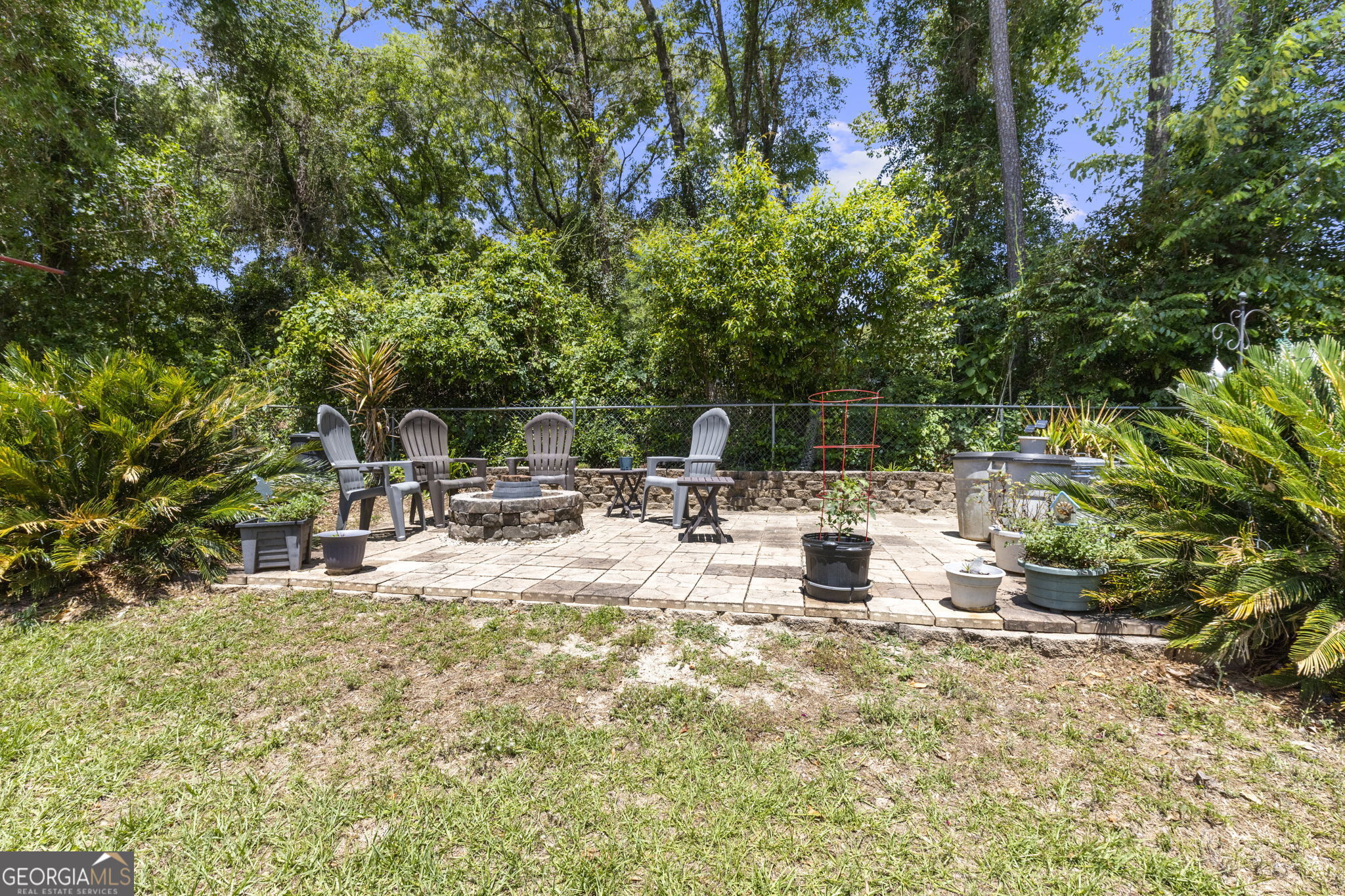 305 North Lake Drive Perry, GA 31069 - Photo 27 of 32 a view of backyard with a table and chairs and potted plants