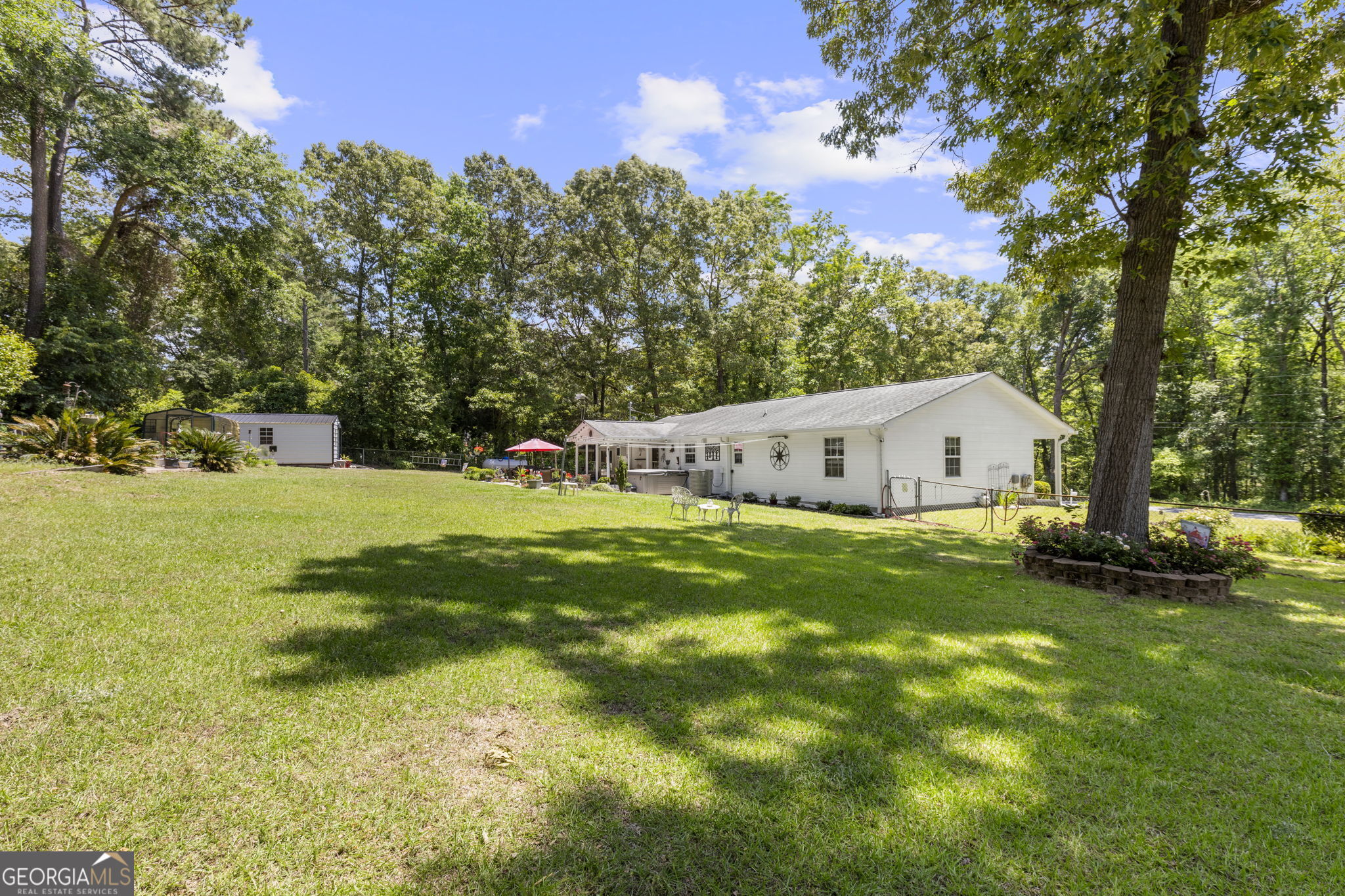 305 North Lake Drive Perry, GA 31069 - Photo 29 of 32 a view of a house with backyard and a tree
