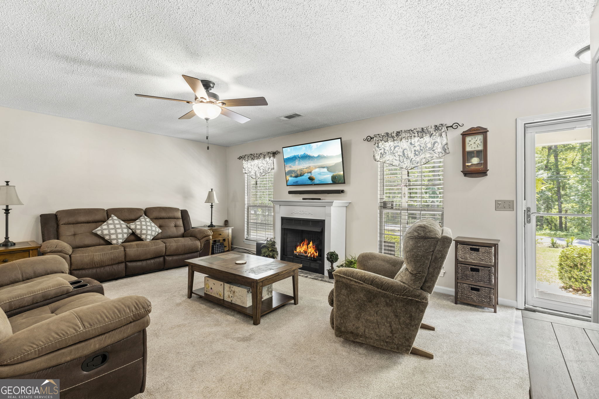 305 North Lake Drive Perry, GA 31069 - Photo 9 of 32 a living room with furniture a fireplace and a large window