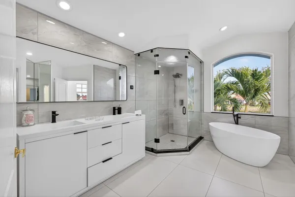 a bathroom with a shower sink and mirror