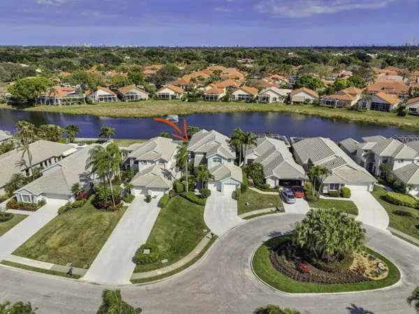 an aerial view of residential houses with outdoor space and lake view