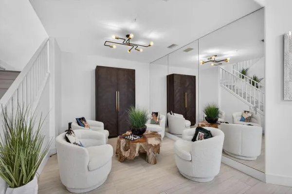 a living room with furniture and a chandelier
