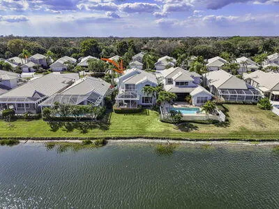 an aerial view of residential houses with outdoor space and swimming pool