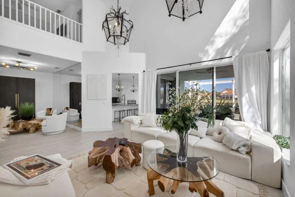 a living room with furniture potted plant and a chandelier