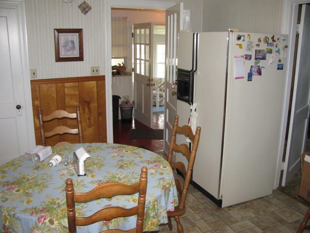 120 Saunders Shop Road Gretna, VA 24557 - Photo 17 of 32 a bedroom with a bed and a refrigerator