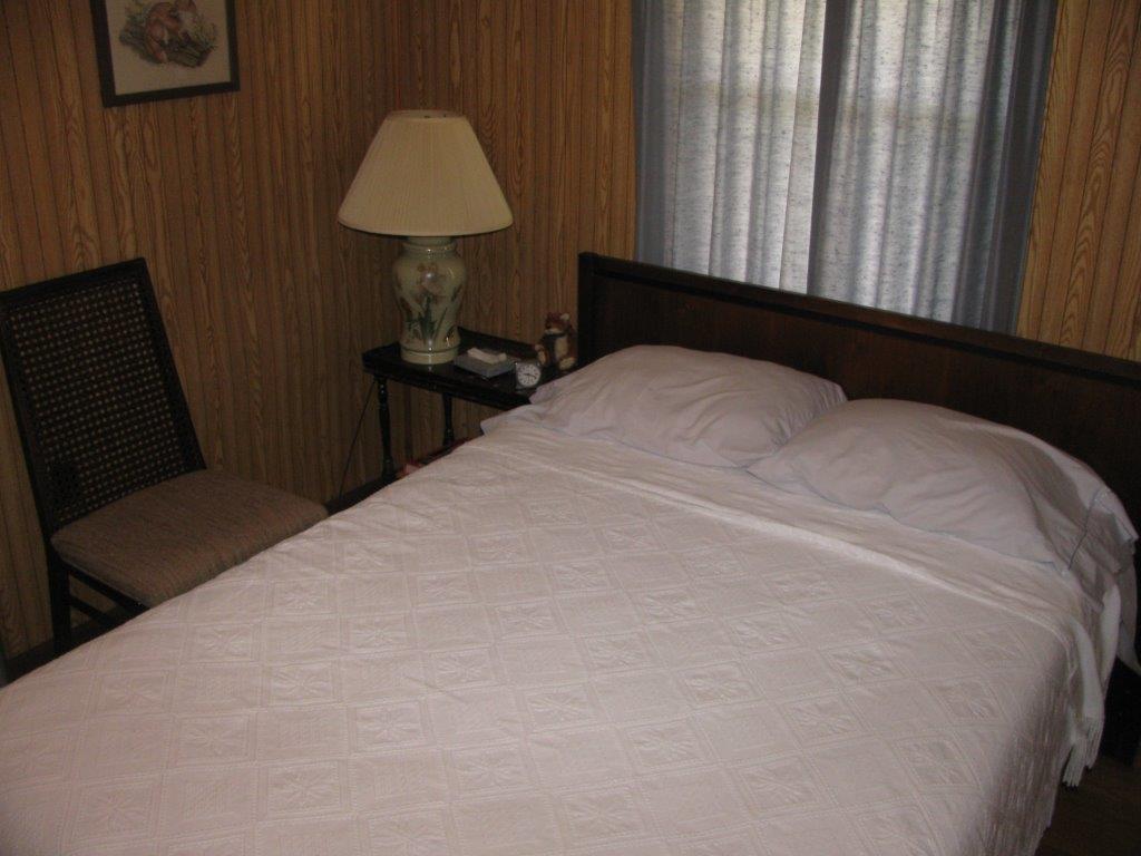 120 Saunders Shop Road Gretna, VA 24557 - Photo 22 of 32 a bedroom with a bed and a table in it