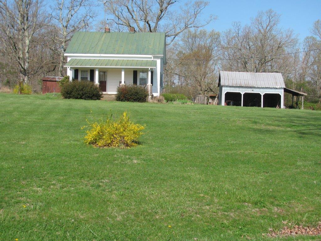 120 Saunders Shop Road Gretna, VA 24557 - Photo 4 of 32 a front view of a house with a garden