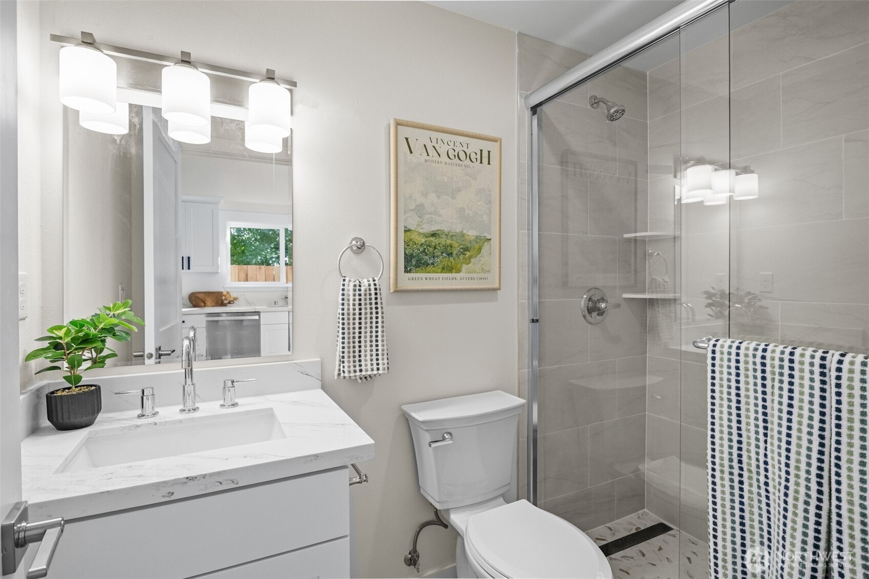 9545 Wallingford Avenue North Seattle, WA 98103 - Photo 12 of 22 a bathroom with a sink a toilet and shower