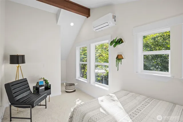 a bedroom with a bed mirror and window