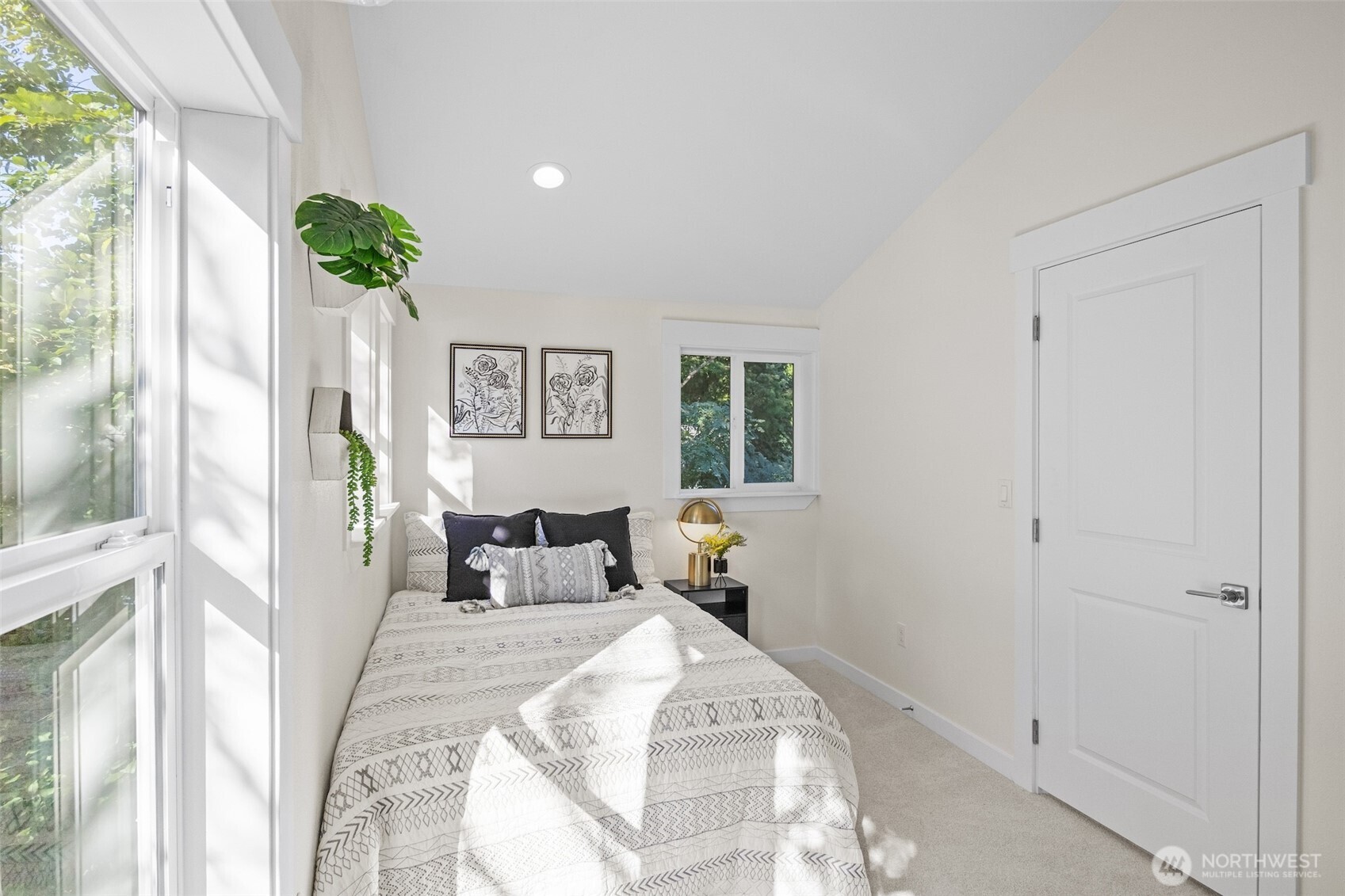 9545 Wallingford Avenue North Seattle, WA 98103 - Photo 16 of 22 a bedroom with a bed mirror and window