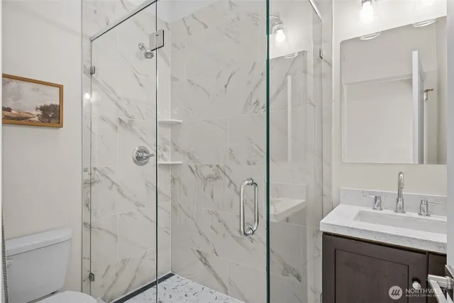 a bedroom with a bed and a painting on the wall