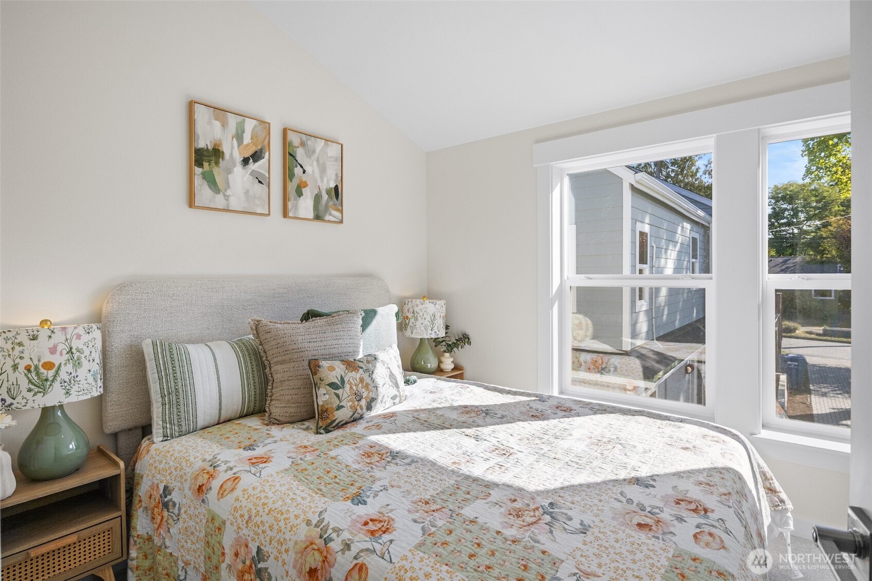 9545 Wallingford Avenue North Seattle, WA 98103 - Photo 20 of 22 a bedroom with a bed and wooden floor