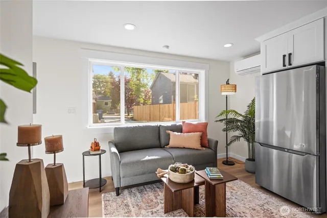 a open kitchen with stainless steel appliances granite countertop a stove top oven a sink dishwasher a dining table and chairs with wooden floor