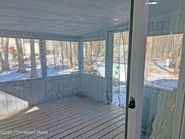 a view of a room with wooden floor and windows