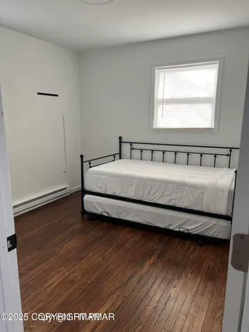 a spacious bedroom with a bed and window