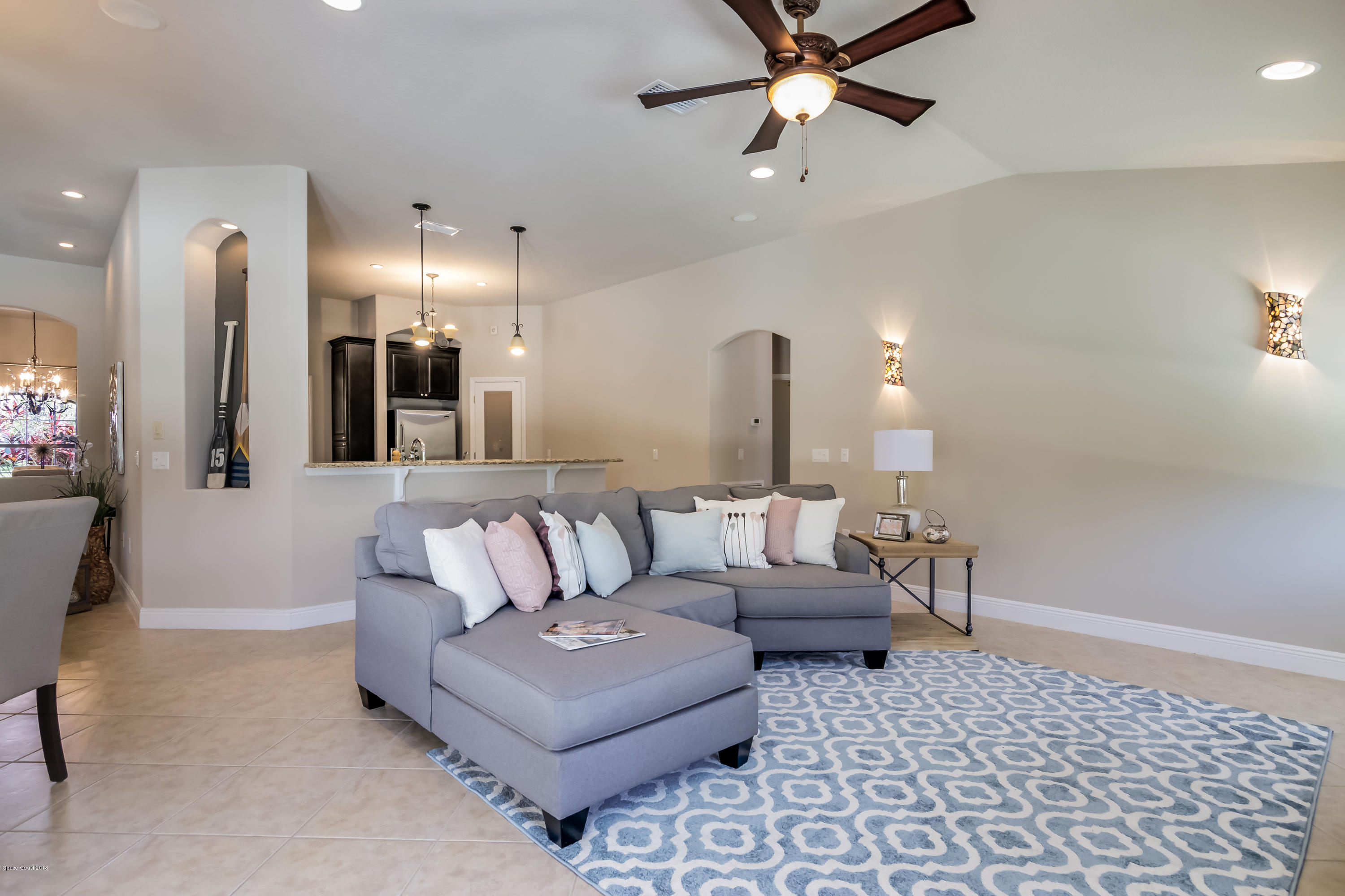 4025 Waterloo Place Melbourne, FL 32940 - Photo 13 of 29 a living room with furniture and a chandelier