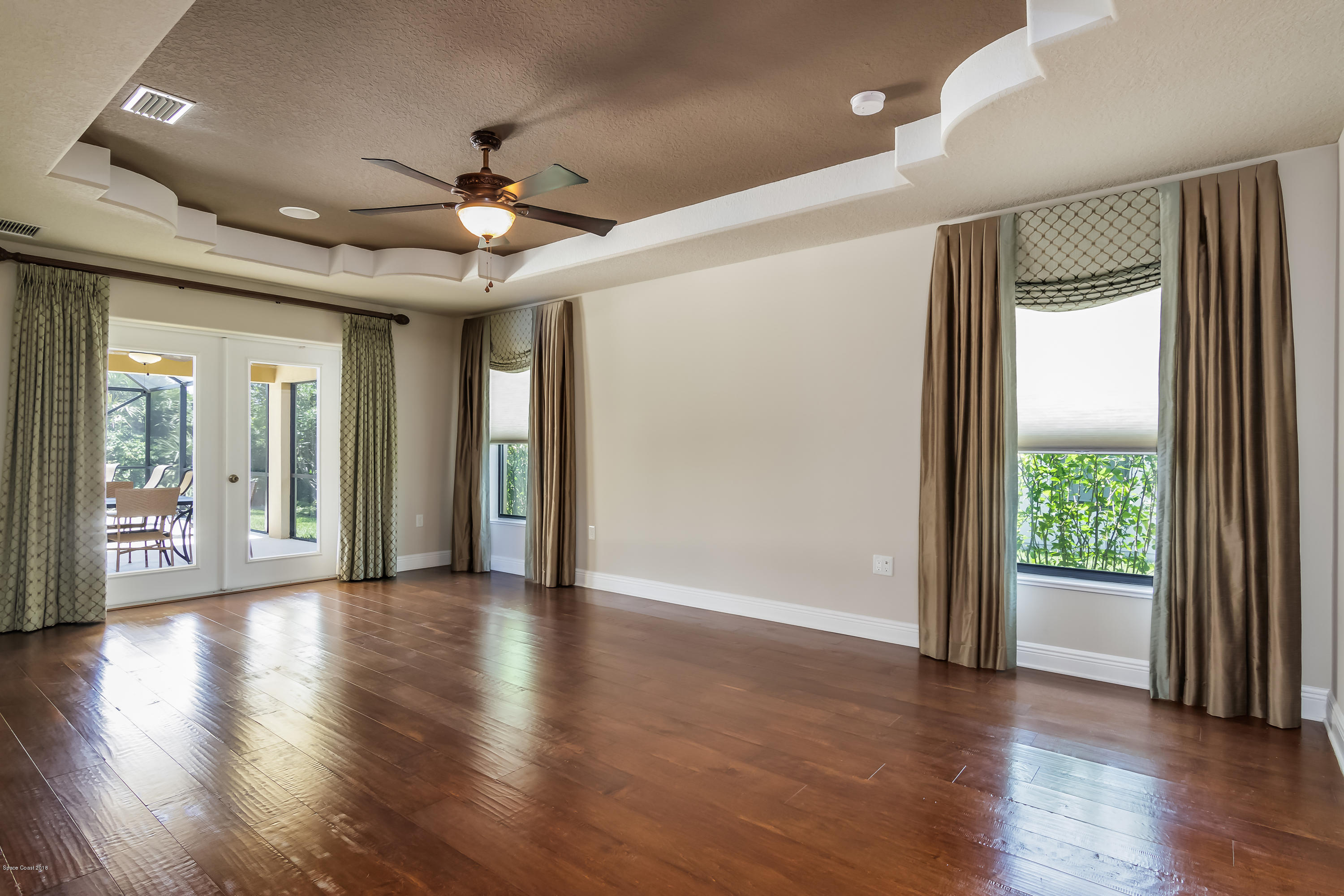 4025 Waterloo Place Melbourne, FL 32940 - Photo 14 of 29 an empty room with wooden floor and windows
