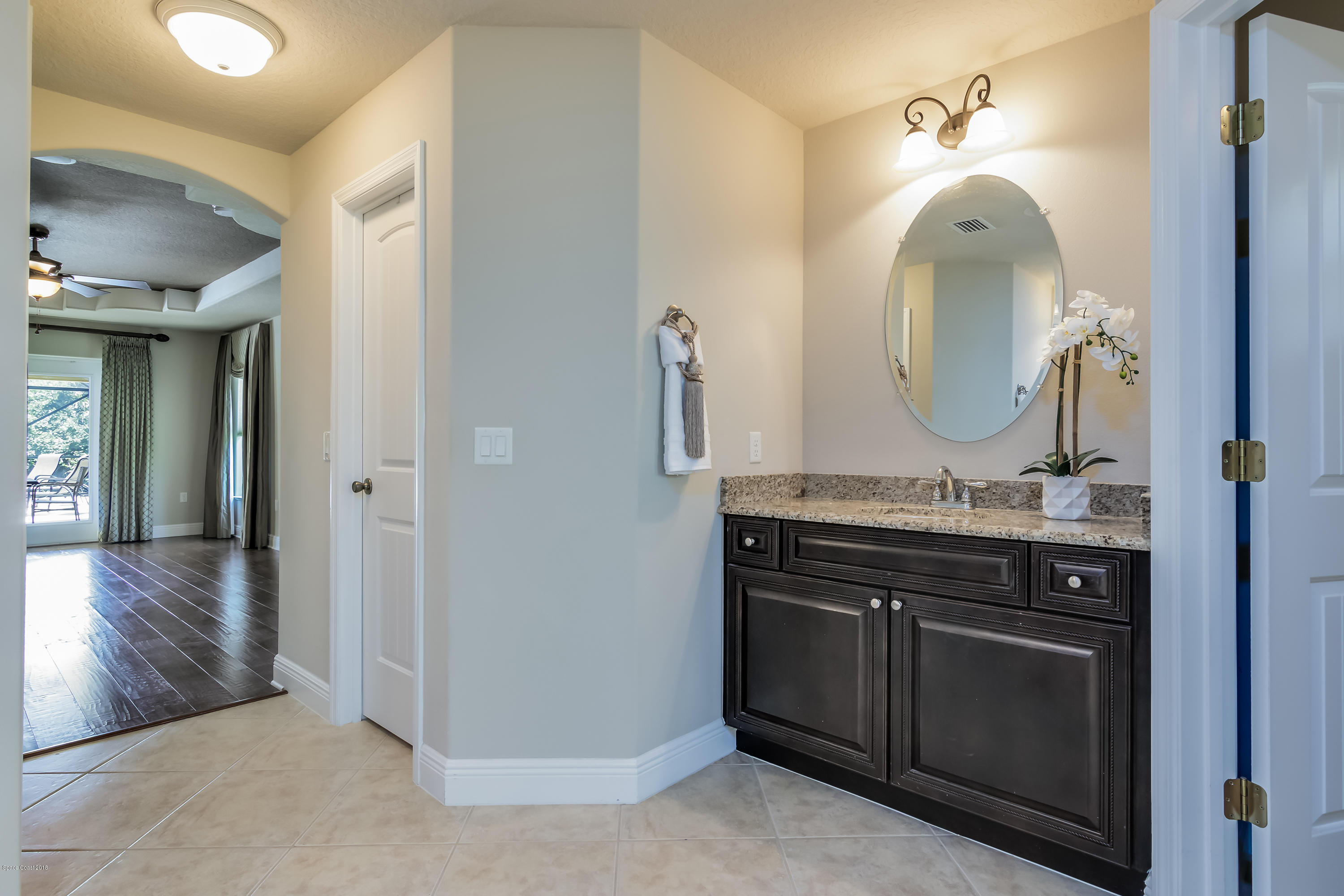 4025 Waterloo Place Melbourne, FL 32940 - Photo 15 of 29 a bathroom with a double vanity sink and a mirror