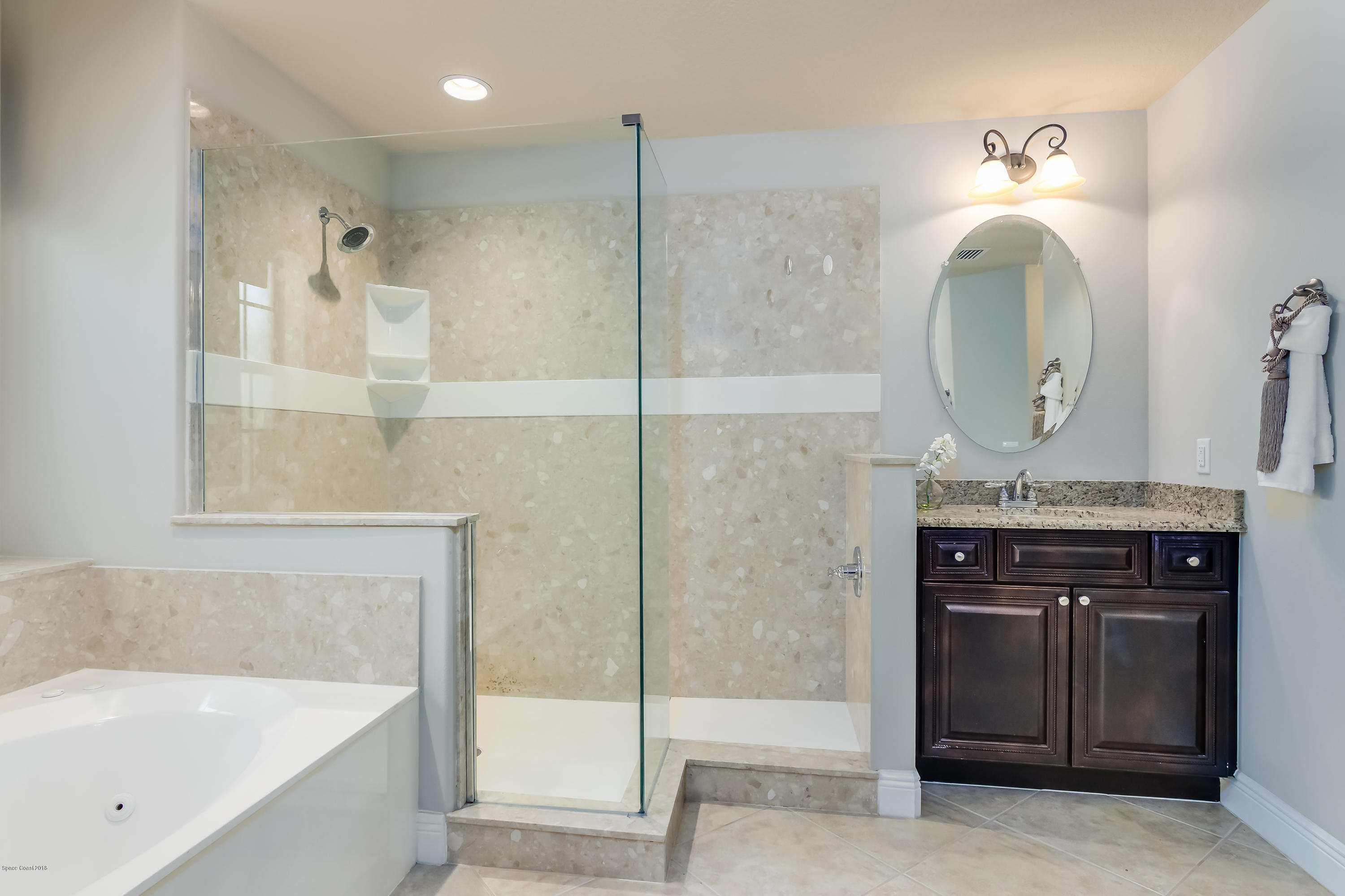 4025 Waterloo Place Melbourne, FL 32940 - Photo 16 of 29 a bathroom with a sink a vanity and a mirror
