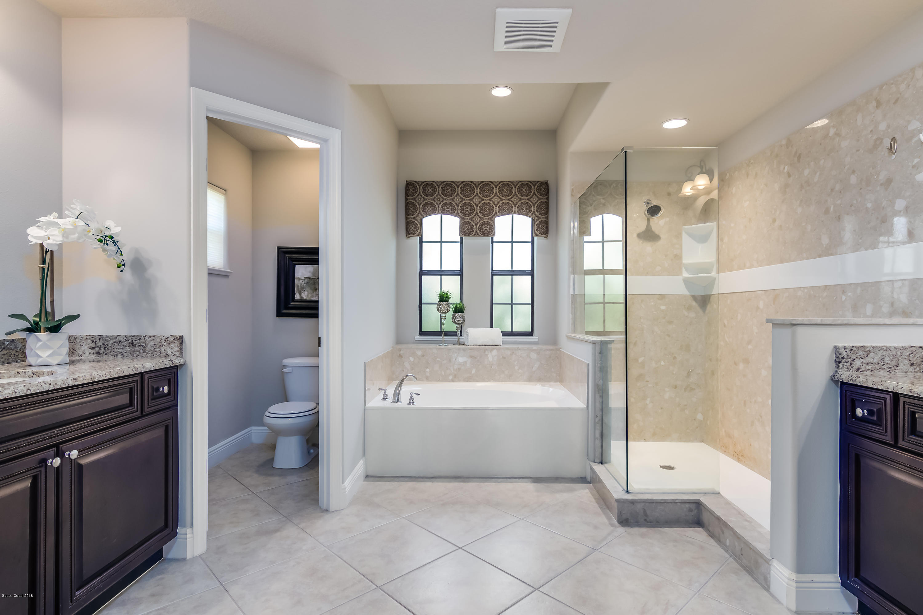 4025 Waterloo Place Melbourne, FL 32940 - Photo 17 of 29 a spacious bathroom with a tub sink shower and mirror