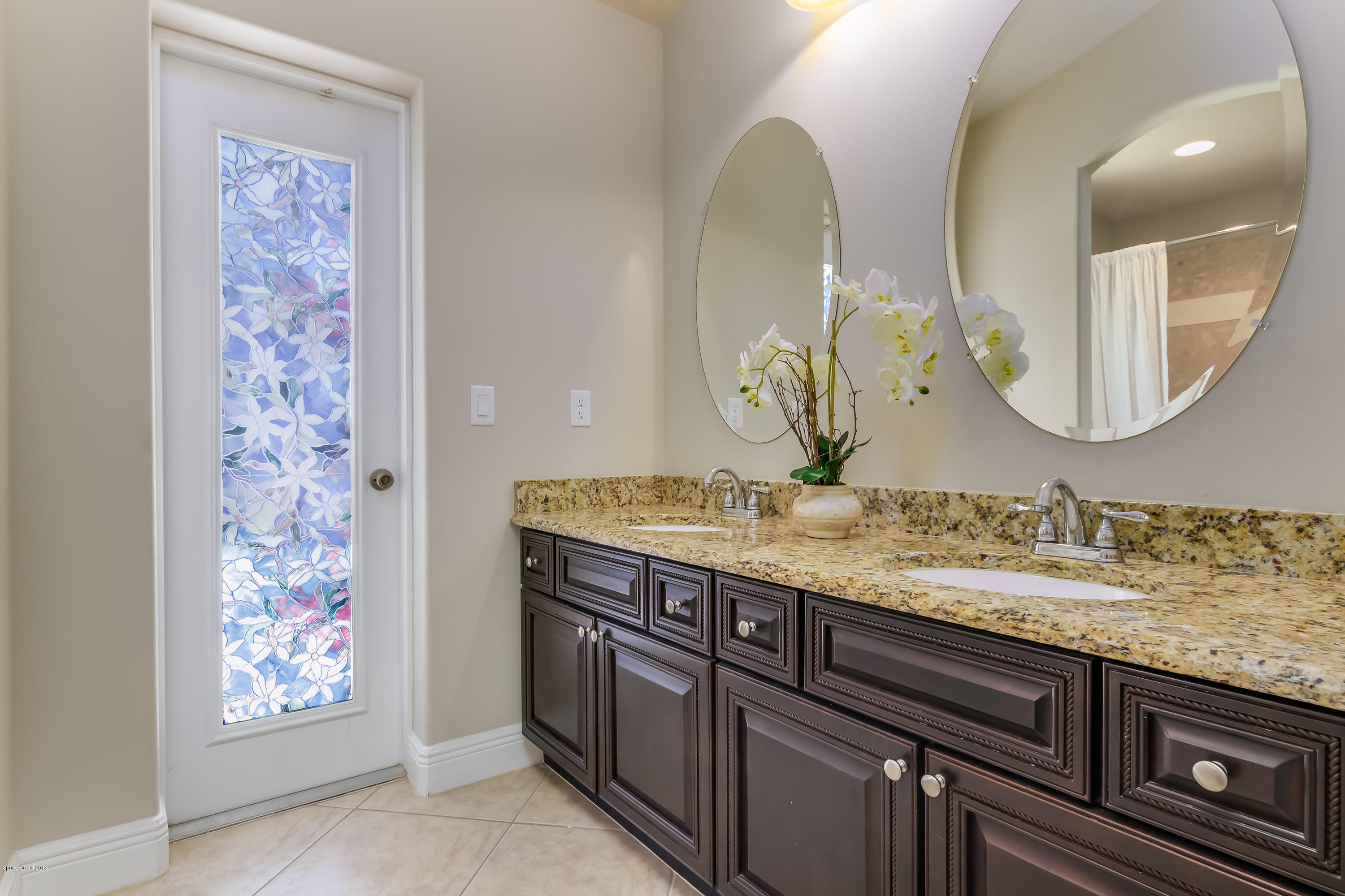 4025 Waterloo Place Melbourne, FL 32940 - Photo 21 of 29 a bathroom with a granite countertop sink a mirror and shower