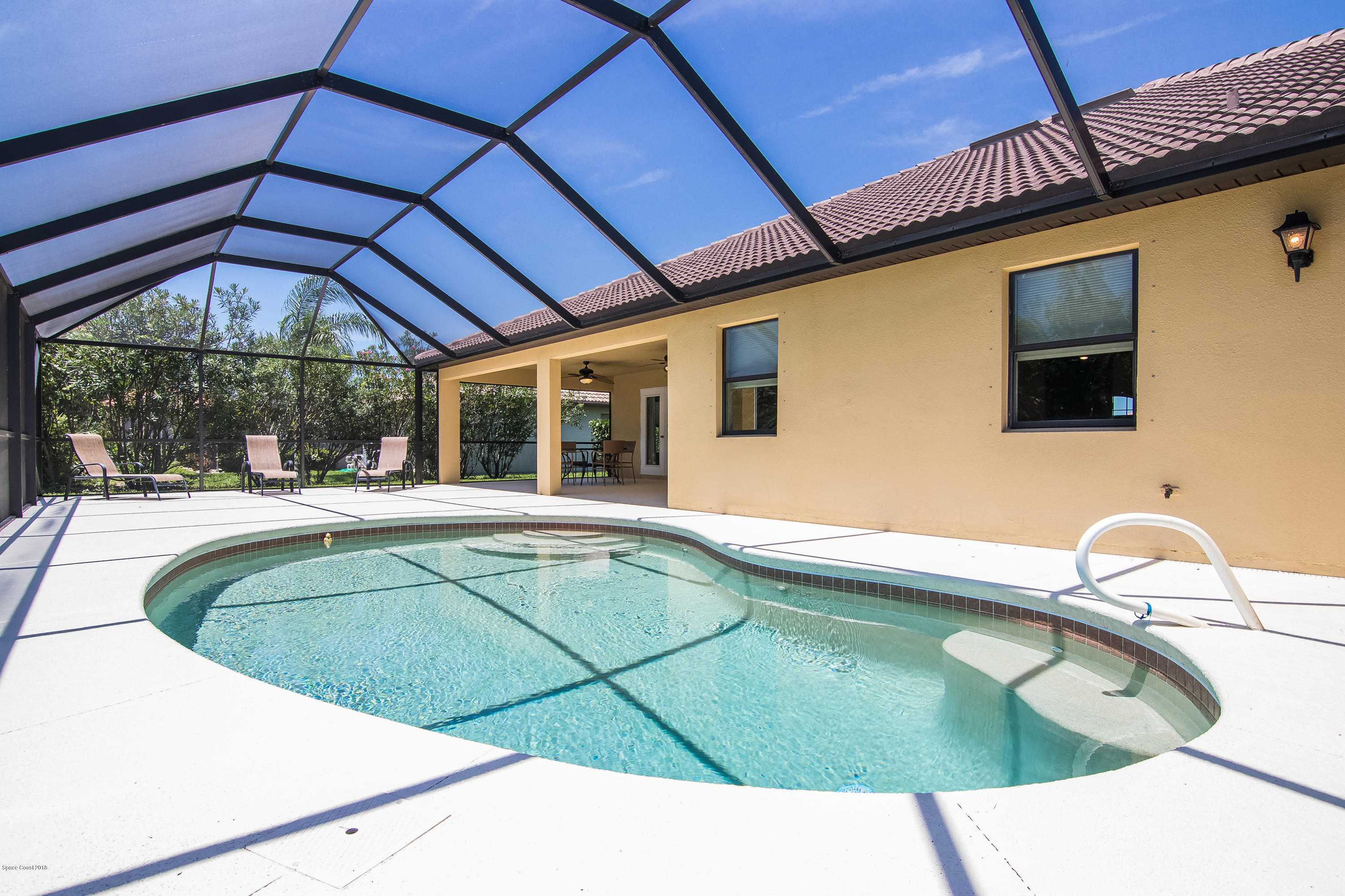 4025 Waterloo Place Melbourne, FL 32940 - Photo 24 of 29 a swimming pool with an outdoor seating
