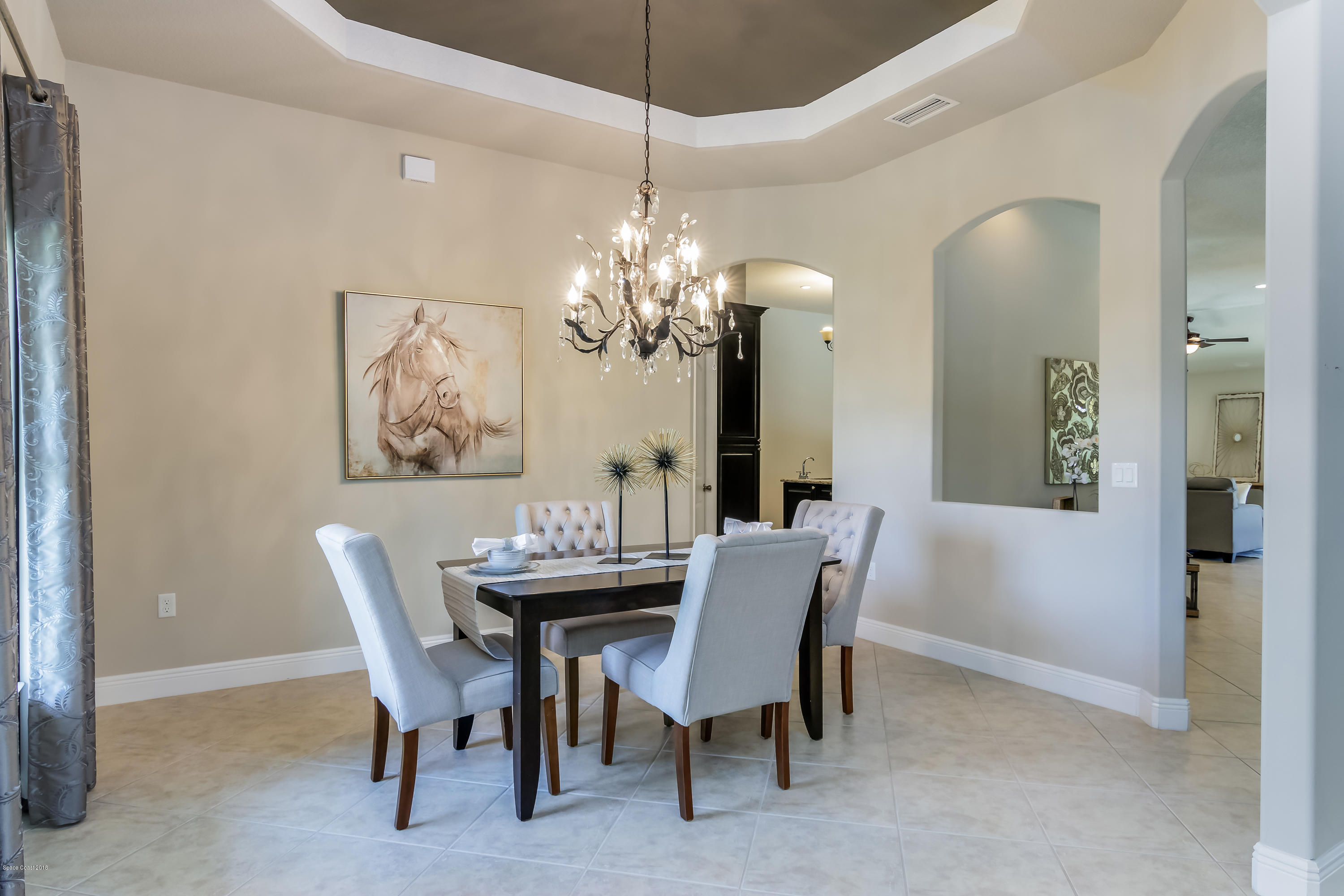 4025 Waterloo Place Melbourne, FL 32940 - Photo 7 of 29 a dining room with furniture and chandelier