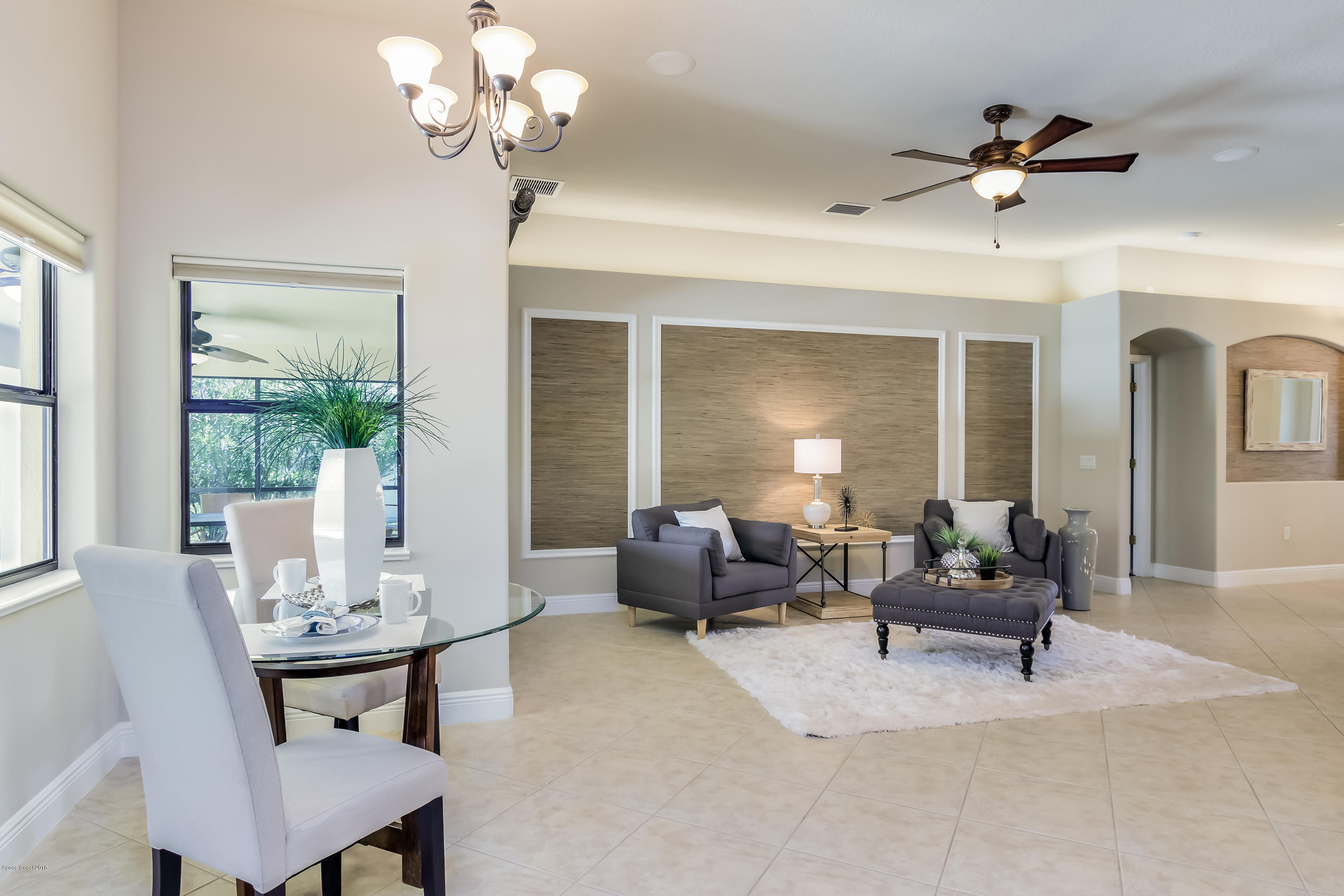 4025 Waterloo Place Melbourne, FL 32940 - Photo 8 of 29 a living room with furniture chandelier and a large window