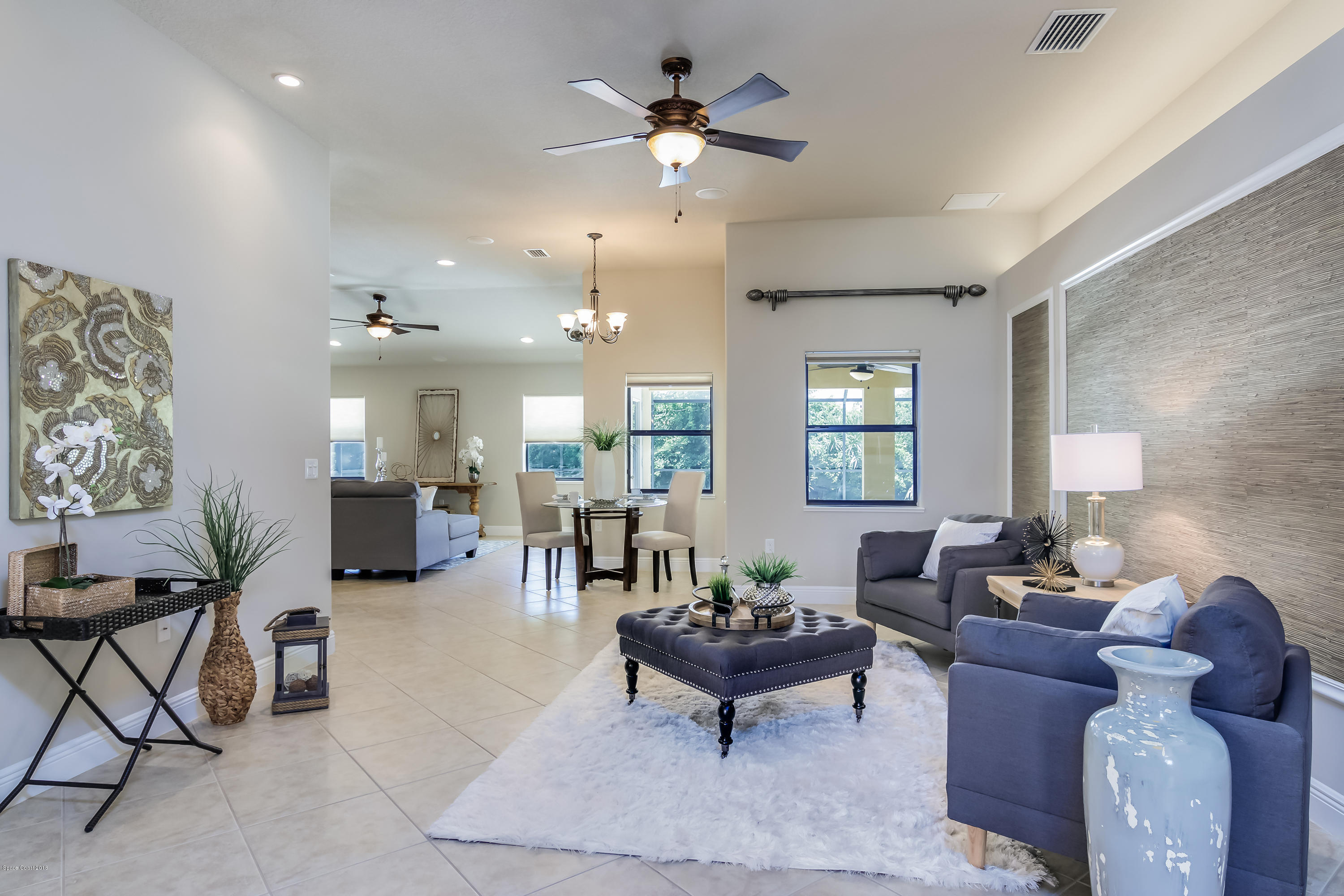4025 Waterloo Place Melbourne, FL 32940 - Photo 9 of 29 a living room with furniture and a chandelier