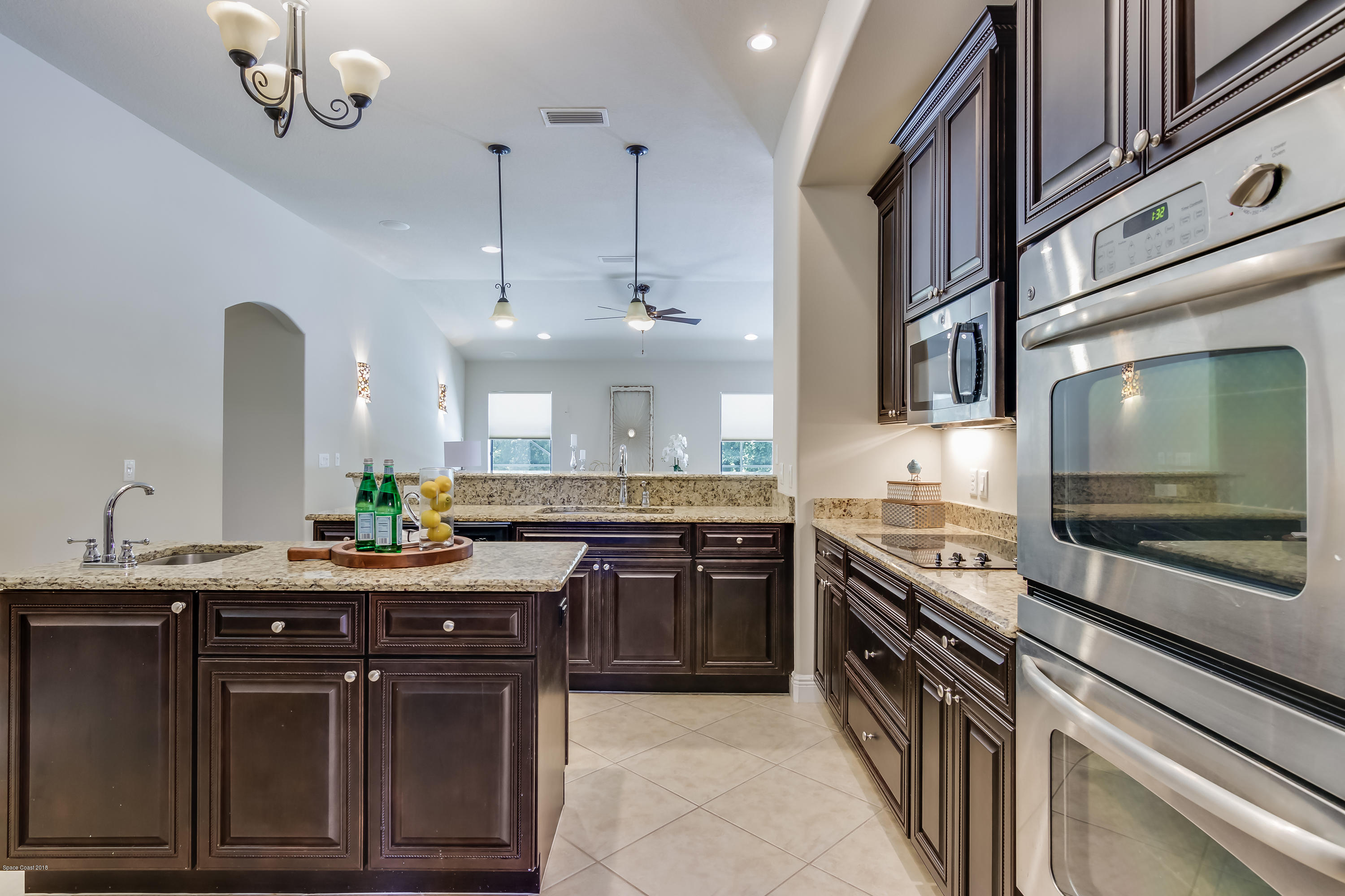4025 Waterloo Place Melbourne, FL 32940 - Photo 10 of 29 a kitchen with stainless steel appliances granite countertop a stove a sink and a microwave