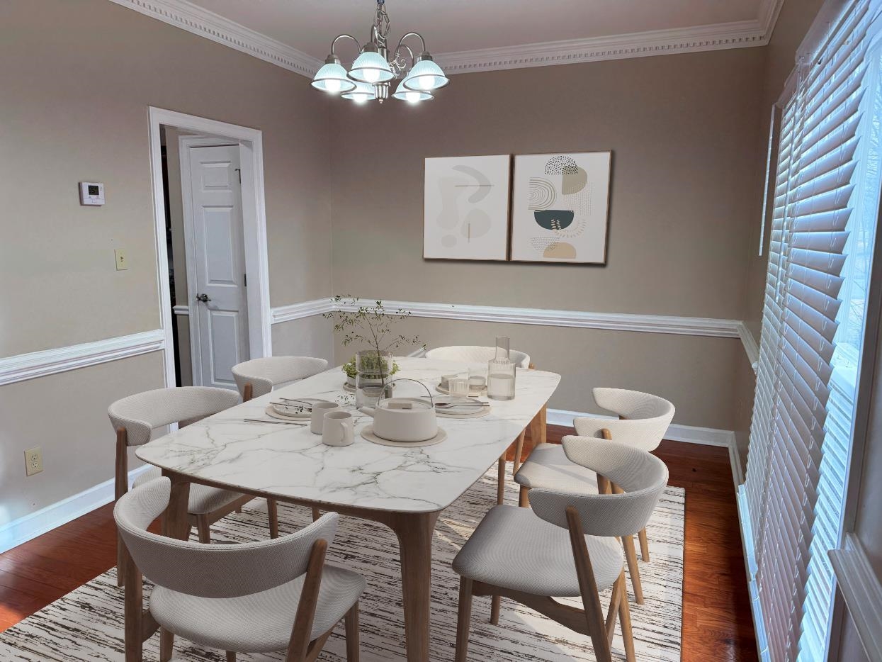 8810 Raspberry Lane Memphis, TN 38016 - Photo 13 of 28 Dining area featuring baseboards, ornamental molding, wood finished floors, and a chandelier