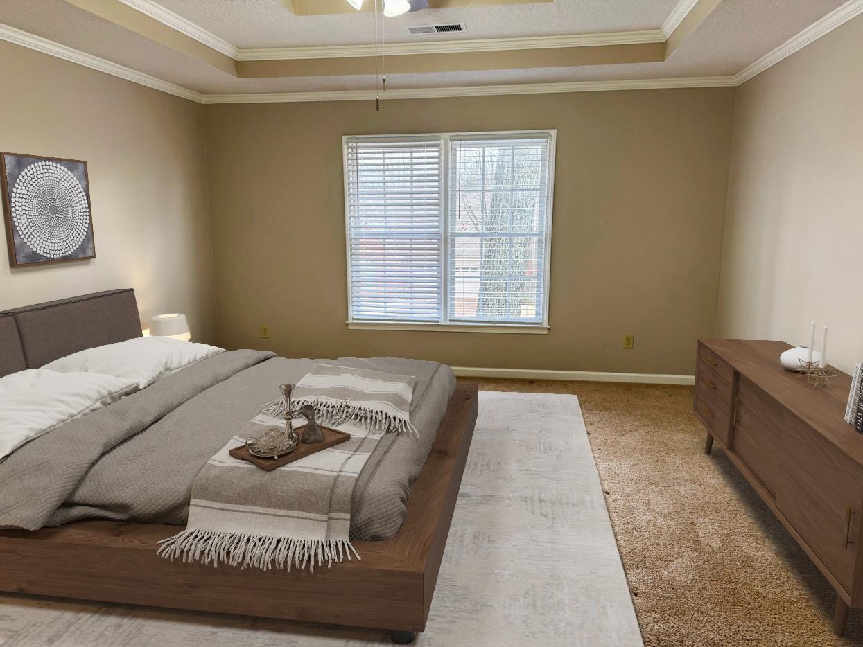 8810 Raspberry Lane Memphis, TN 38016 - Photo 17 of 28 Carpeted bedroom featuring a tray ceiling, a ceiling fan, baseboards, visible vents, and ornamental molding