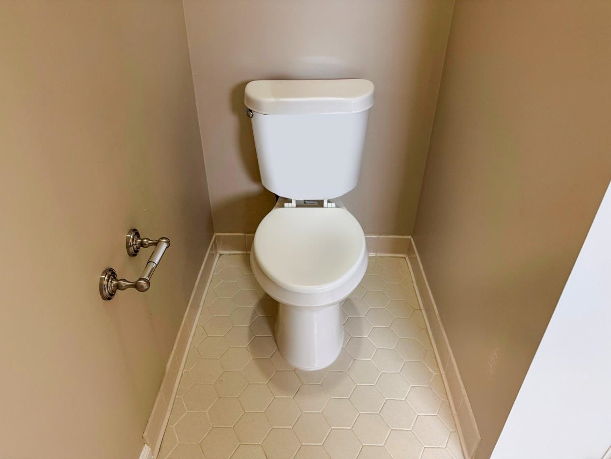 8810 Raspberry Lane Memphis, TN 38016 - Photo 23 of 28 Bathroom with baseboards, toilet, and tile patterned floors