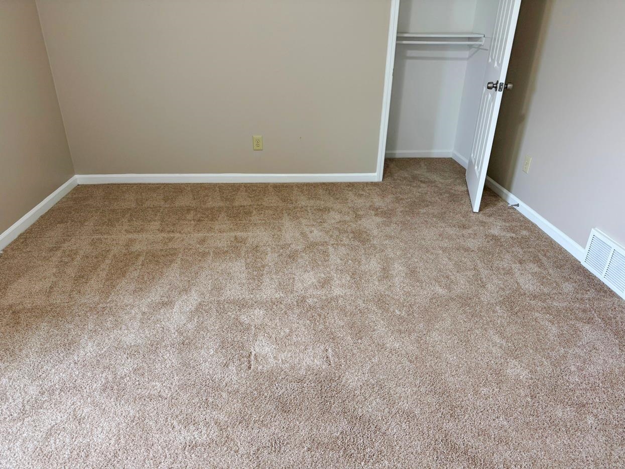 8810 Raspberry Lane Memphis, TN 38016 - Photo 25 of 28 Unfurnished bedroom with carpet floors, baseboards, a closet, and visible vents