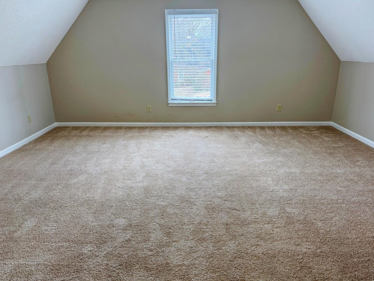 8810 Raspberry Lane Memphis, TN 38016 - Photo 26 of 28 Bonus room with baseboards, vaulted ceiling, and carpet flooring