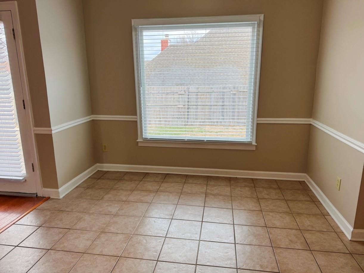8810 Raspberry Lane Memphis, TN 38016 - Photo 9 of 28 Unfurnished room featuring baseboards and light tile patterned floors